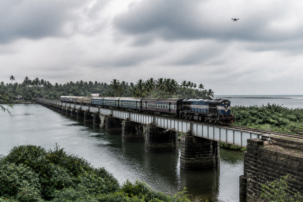 Drone flight near a Kerala railway bridge spanning the sea and backwaters