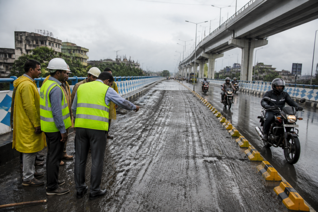 Chingrighata flyover in Kolkata with safety blocks installed after motorcycles skidded on wet road paint