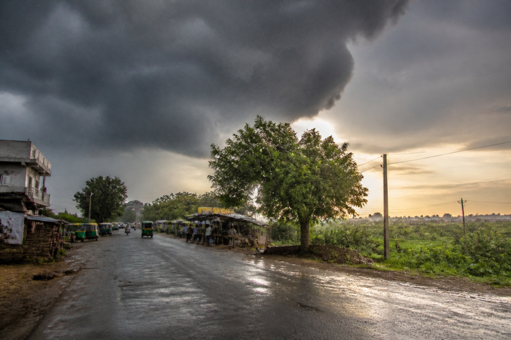 Gujarat weather forecast showing rain clouds over a dry urban road in south Gujarat
