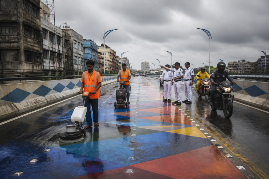 Kolkata rainbow roads being scrubbed on a flyover after rain-related safety concerns