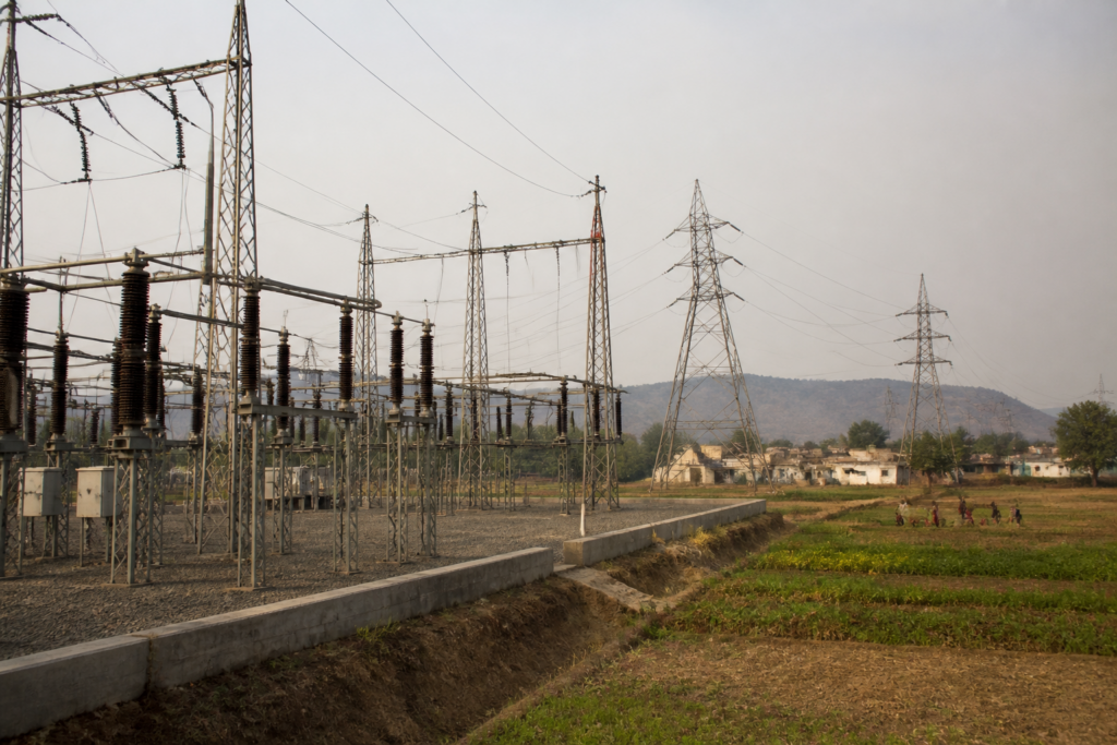 Telangana power crisis represented by an electricity substation near rural farmland