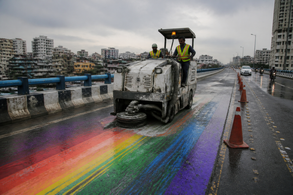 Rainbow paint being removed from a Kolkata flyover after motorbikes skidded on the surface
