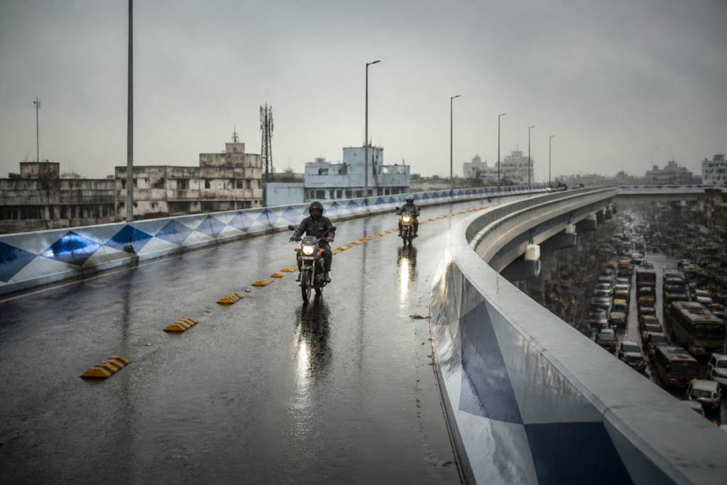 Kolkata flyover accident site on the wet Chingrighata Flyover with road studs and traffic controls