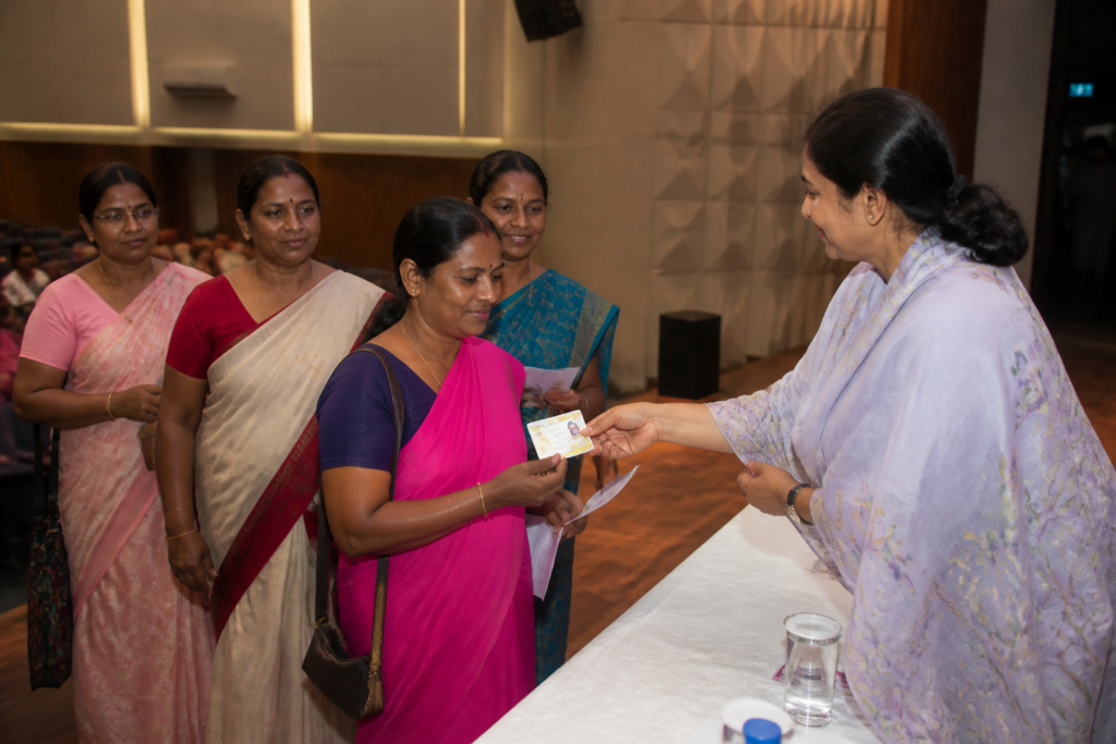 Anganwadi workers receiving health cards at a Kolkata welfare event