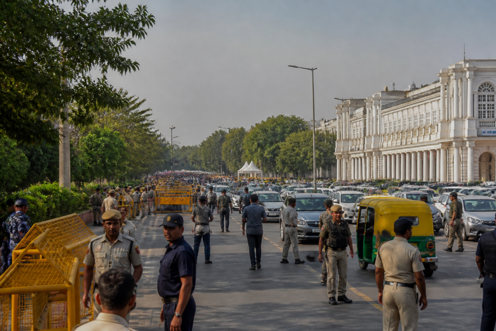 Delhi traffic restrictions near Connaught Place with police barricades and commuters during a security deployment