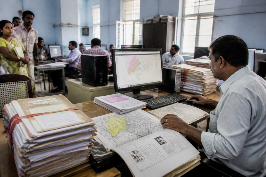 Dharani land records review at a Telangana revenue office with property documents and digital records