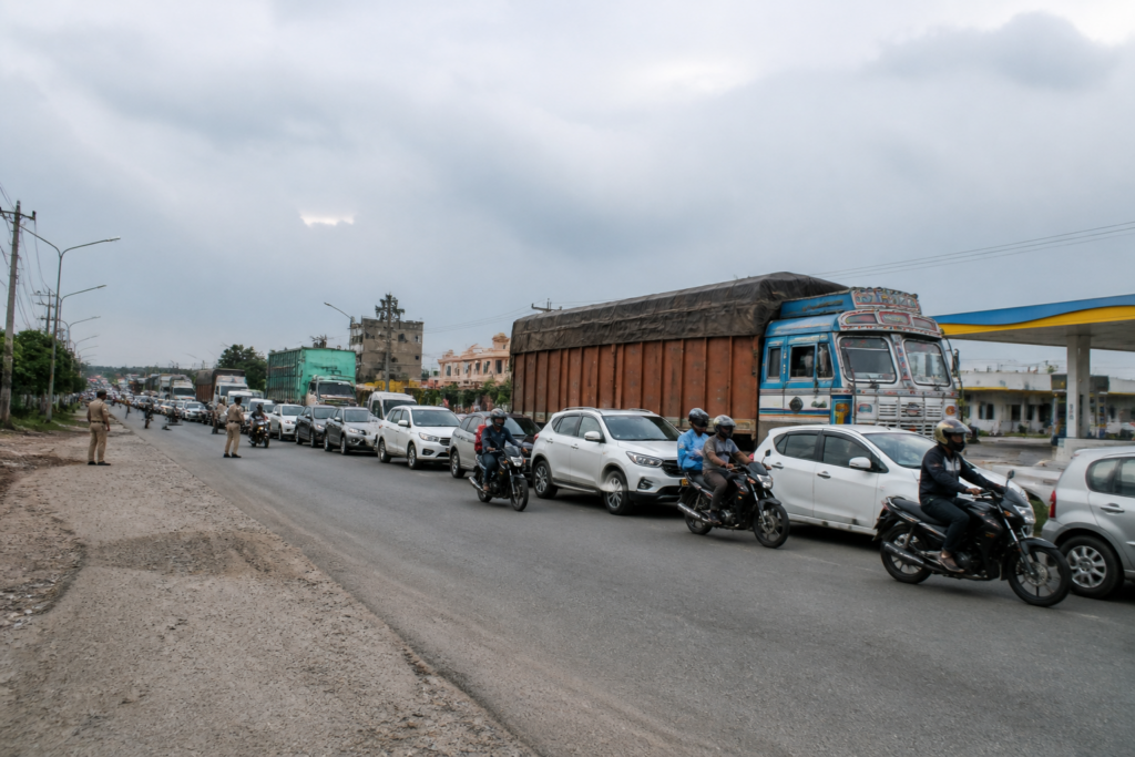 Seraikela road accident scene on a bypass with a truck and stopped traffic near a petrol pump