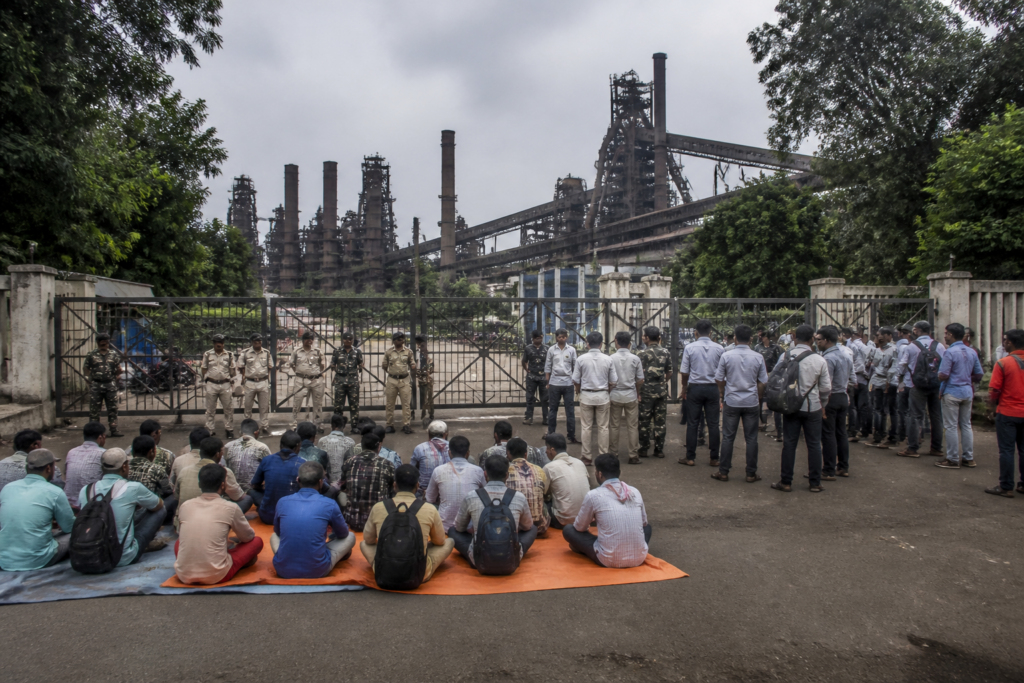 Bokaro Steel Plant protest near a blocked gate with displaced job-seekers gathered outside