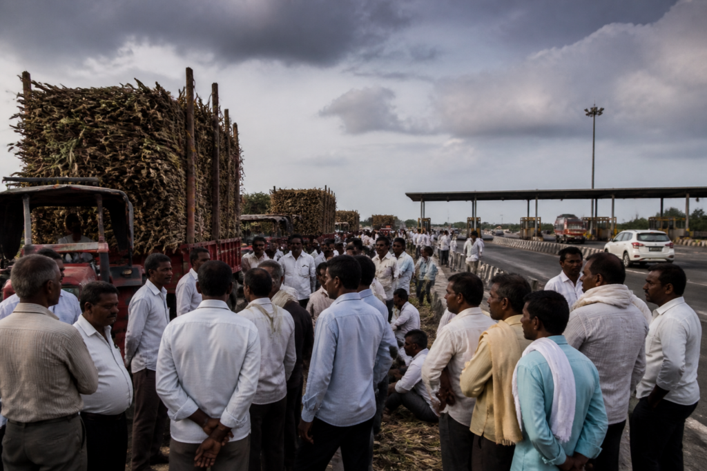 Sugarcane farmers protest near a Maharashtra highway toll plaza