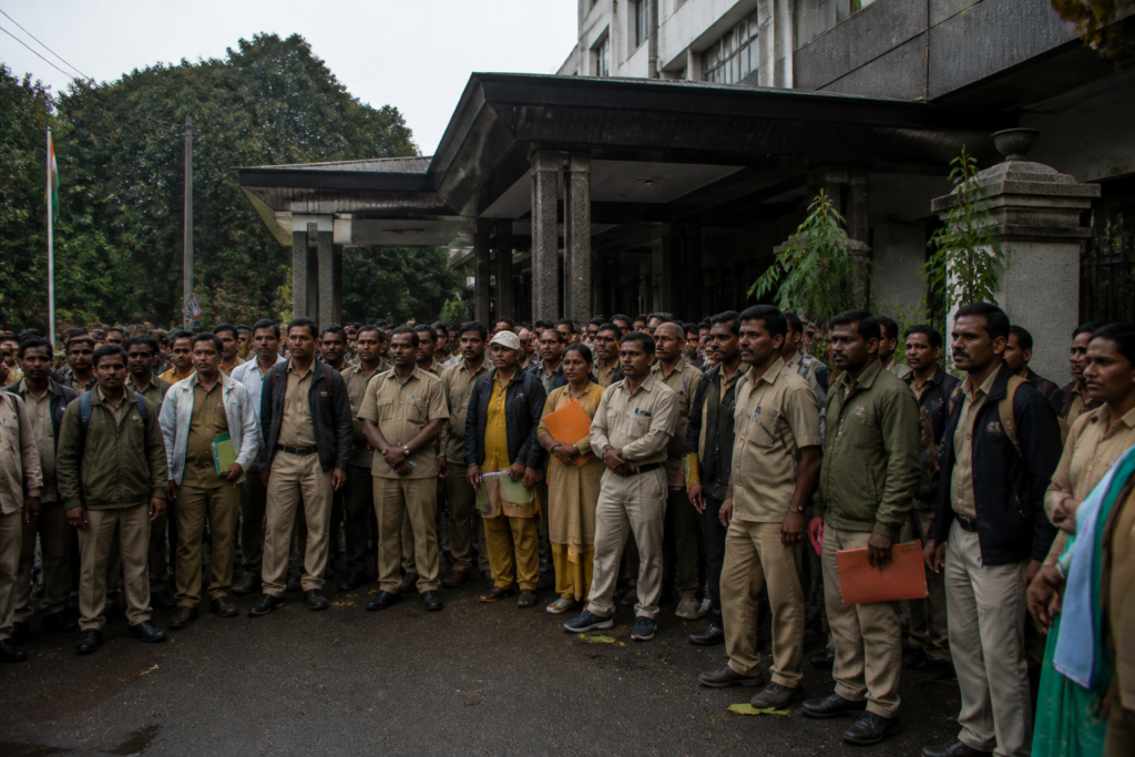 Karnataka forest workers gathering for a protest outside a government forest department office