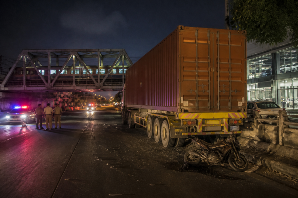 Ahmedabad container truck accident site near Sanathal railway bridge at night