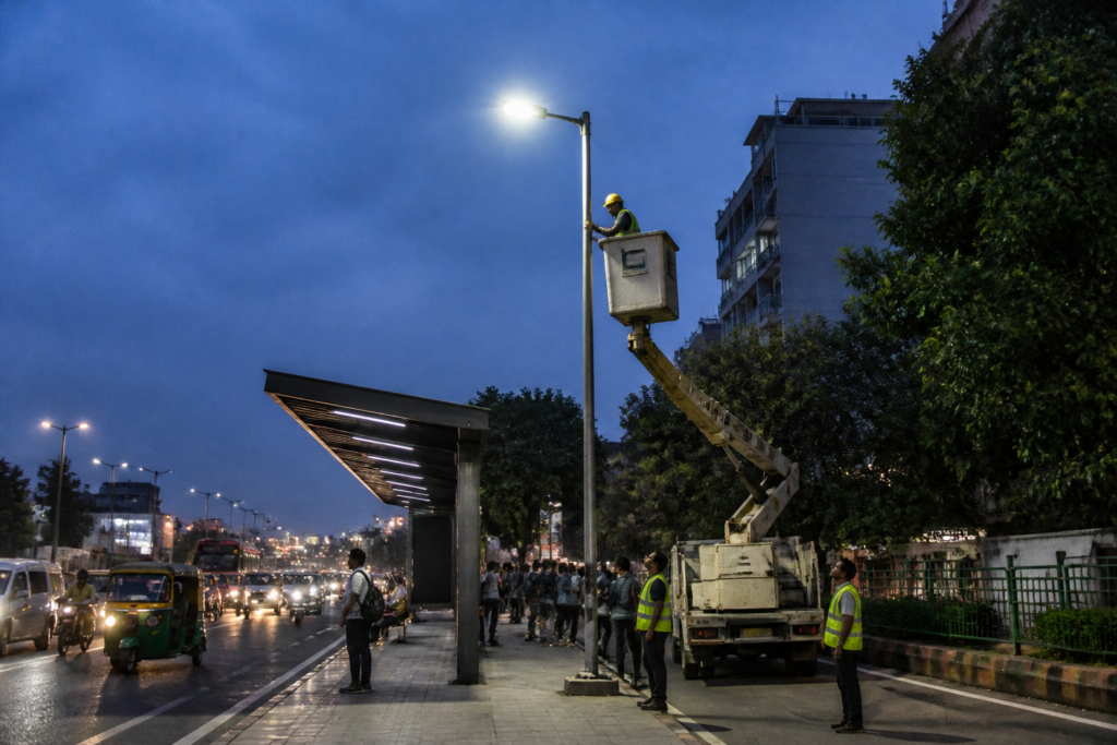 Delhi smart LED street lights being installed near an urban bus stop