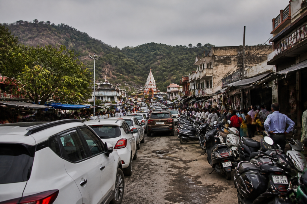 Traffic congestion and roadside parking near Kalka temple during a busy period