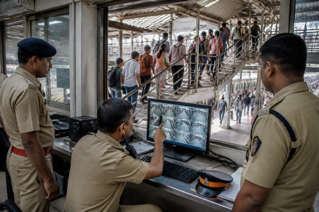 Mumbai GRP personnel reviewing CCTV footage from a suburban railway station
