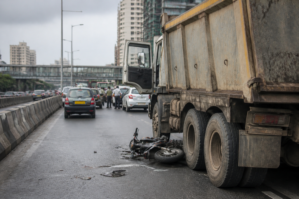 Mumbai road crash scene involving a motorcycle and dumper on the Western Express Highway