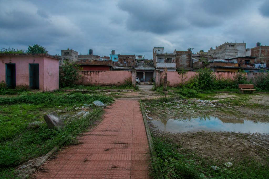 Pink parks Delhi: neglected women’s park with broken boundary, overgrown vegetation and stagnant water