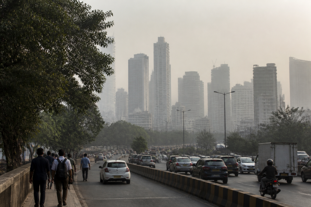 Mumbai air pollution haze over a busy urban road with buildings in the background