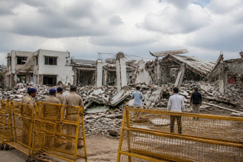 Secunderabad unauthorised function hall demolition site with rubble and collapsed structural pillars