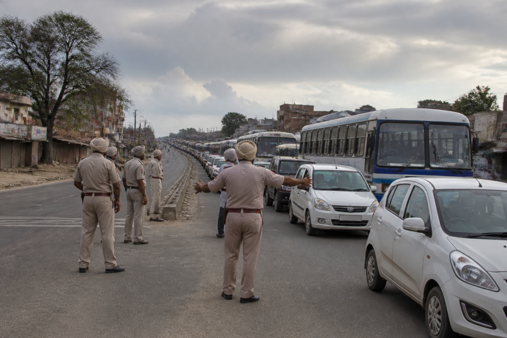 Punjab bandh disrupts traffic on a highway as police manage movement during the protest.