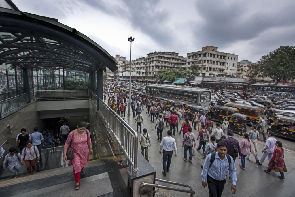 Pune Metro station access amid congested streets, pedestrians, vehicles and surrounding urban activity