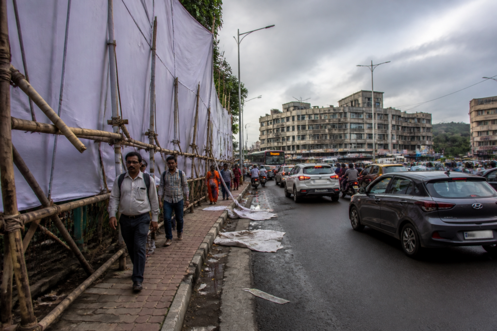Pune illegal flex banners blocking a footpath near a busy road junction