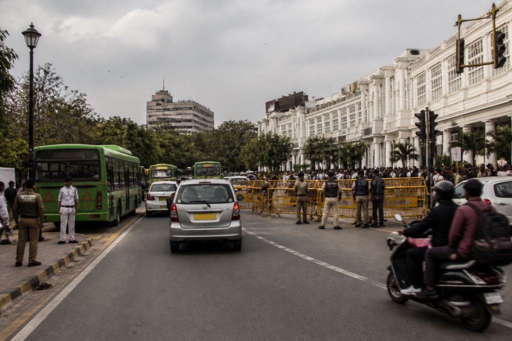 Delhi traffic curbs near Connaught Place with police managing vehicles and commuters