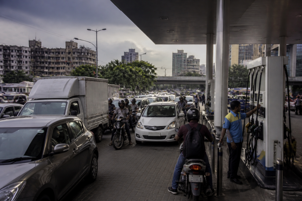 Petrol diesel prices India shown at an urban fuel station with vehicles waiting