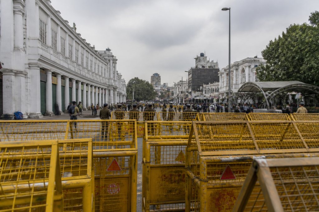 Delhi protests near a barricaded commercial street in Central Delhi