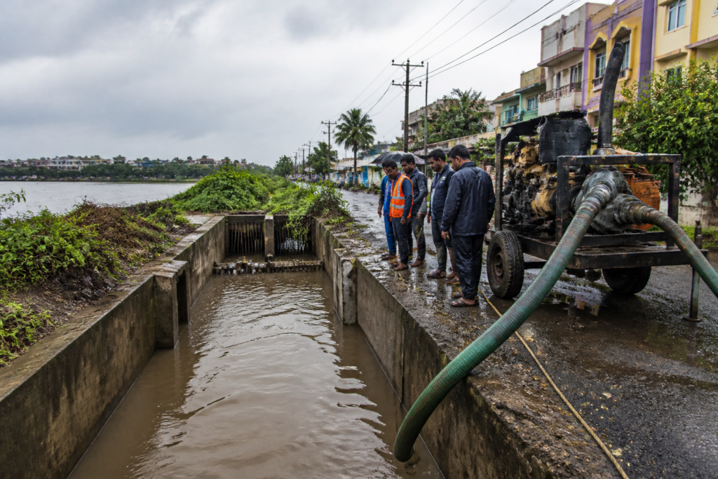 Chennai monsoon preparedness works near a storm-water drain and flood-prone urban road