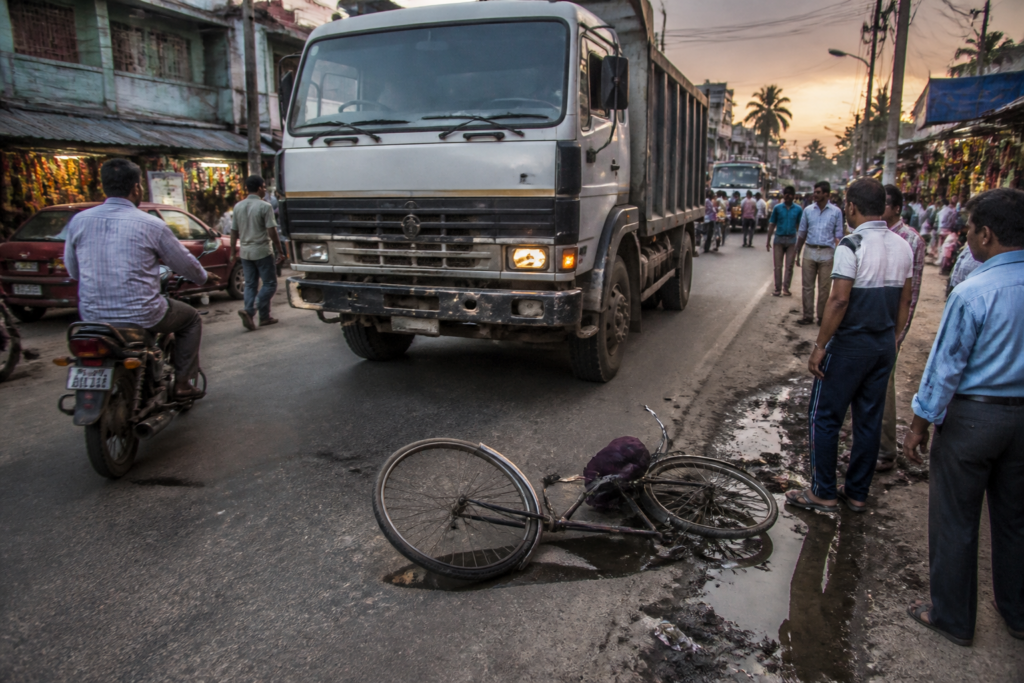 Bangaon road accident scene near Yashore Road involving a truck and cyclist