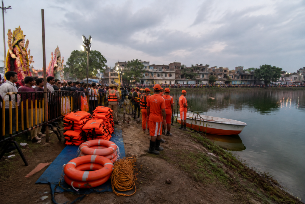 Hazaribag idol immersion safety arrangements with barricades and rescue equipment near a water body