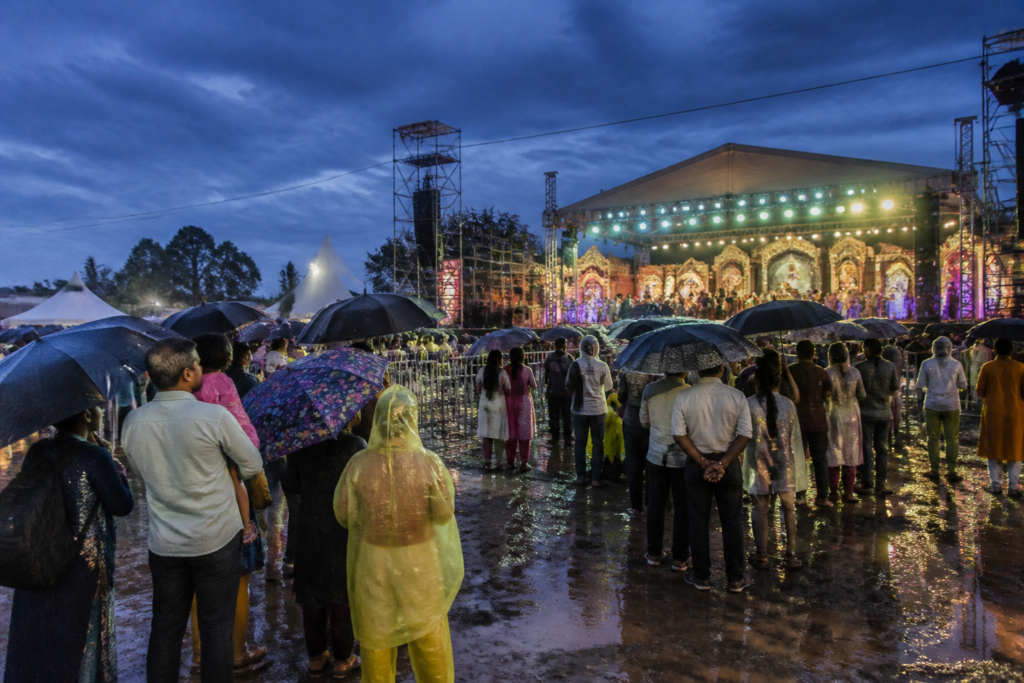 Visitors attend Yuva Dasara in the rain near Uttanahalli, Mysuru.