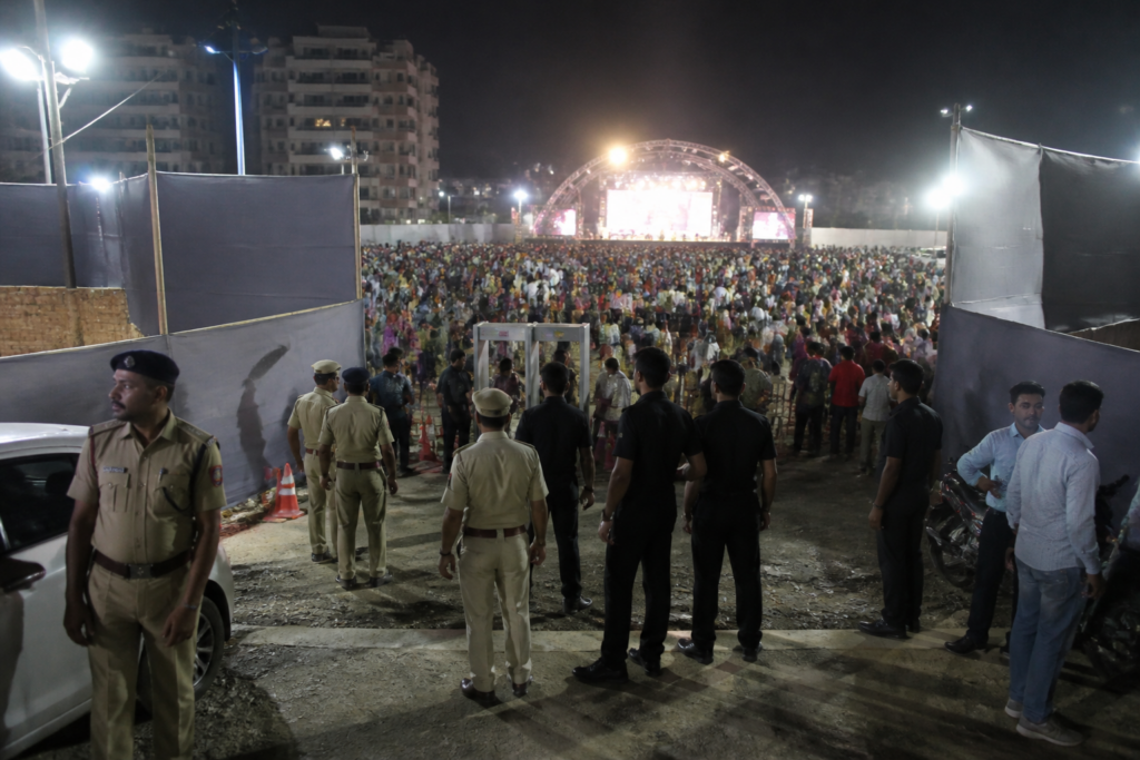 Ahmedabad garba event venue with security personnel and attendees during a night gathering