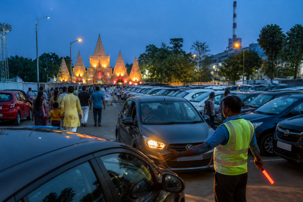 Durgapur parking area during Durga Puja with cars and visitors facing fee-related complaints
