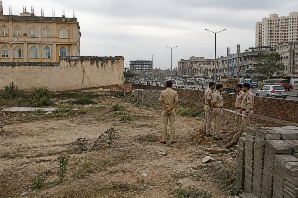 Police presence near a disputed Ghaziabad land plot after a fatal shooting