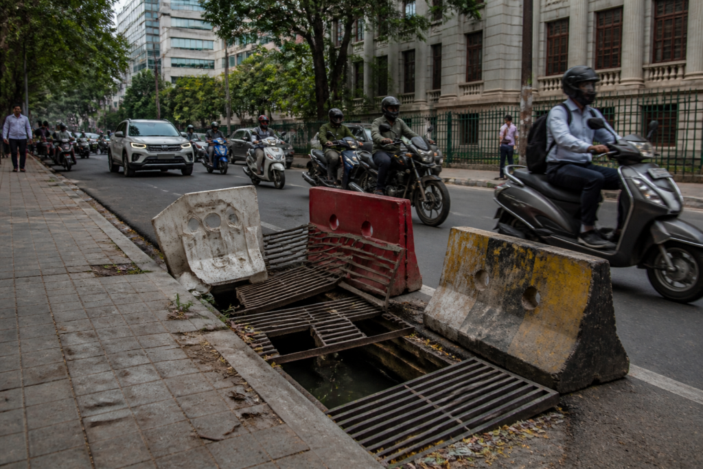 Broken Nrupathunga Road gratings barricaded on a busy Bengaluru CBD street