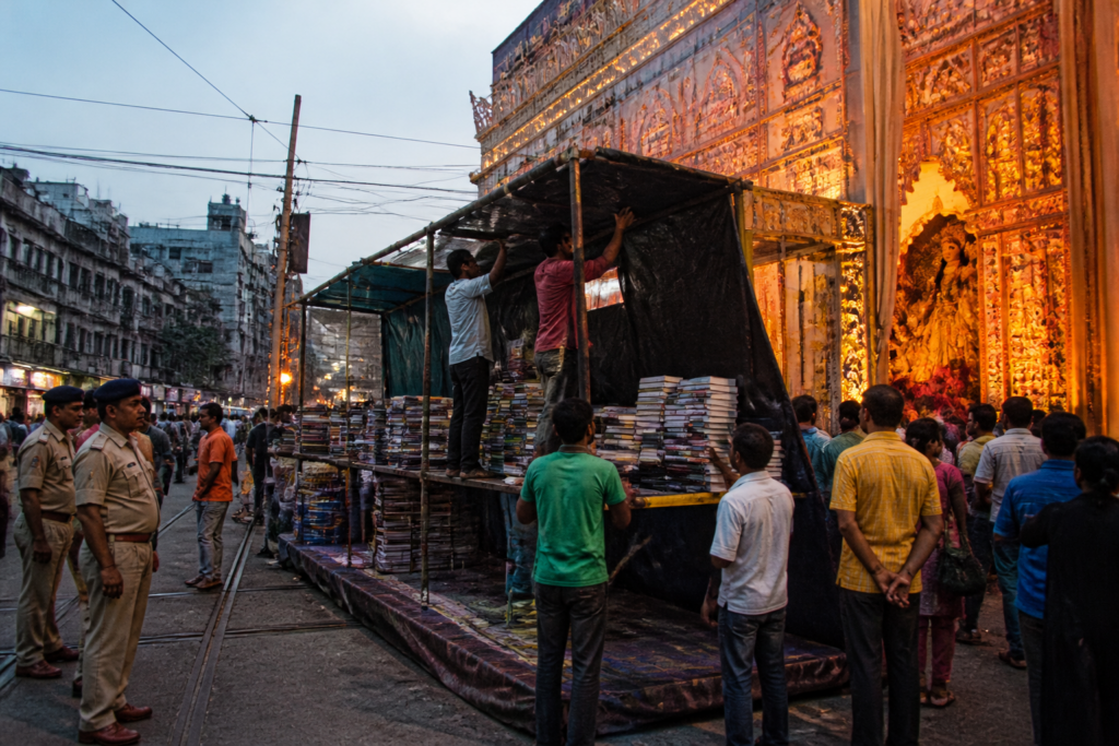 Kolkata Puja book stalls being assembled outside a city pandal during the festive season