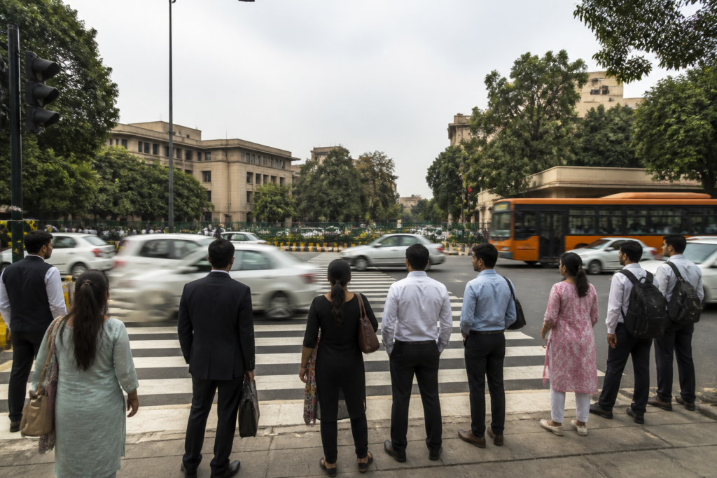 Delhi High Court pedestrian crossing on busy Mathura Road with vehicles and pedestrians