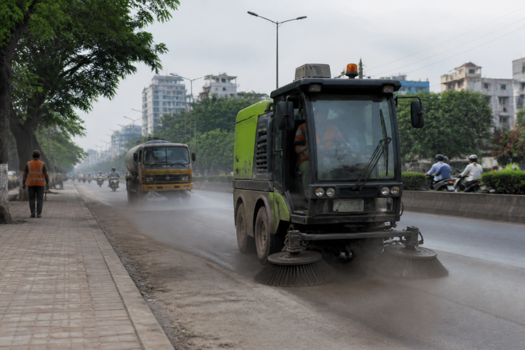 Pune air pollution funds used for road dust control on a busy urban street
