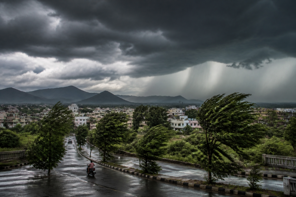 Maharashtra weather yellow alert with dark storm clouds and rain over an urban road