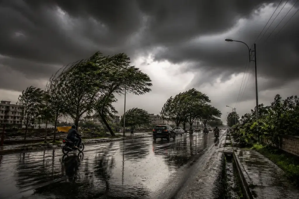 Maharashtra weather alert with dark storm clouds and rain over an urban road