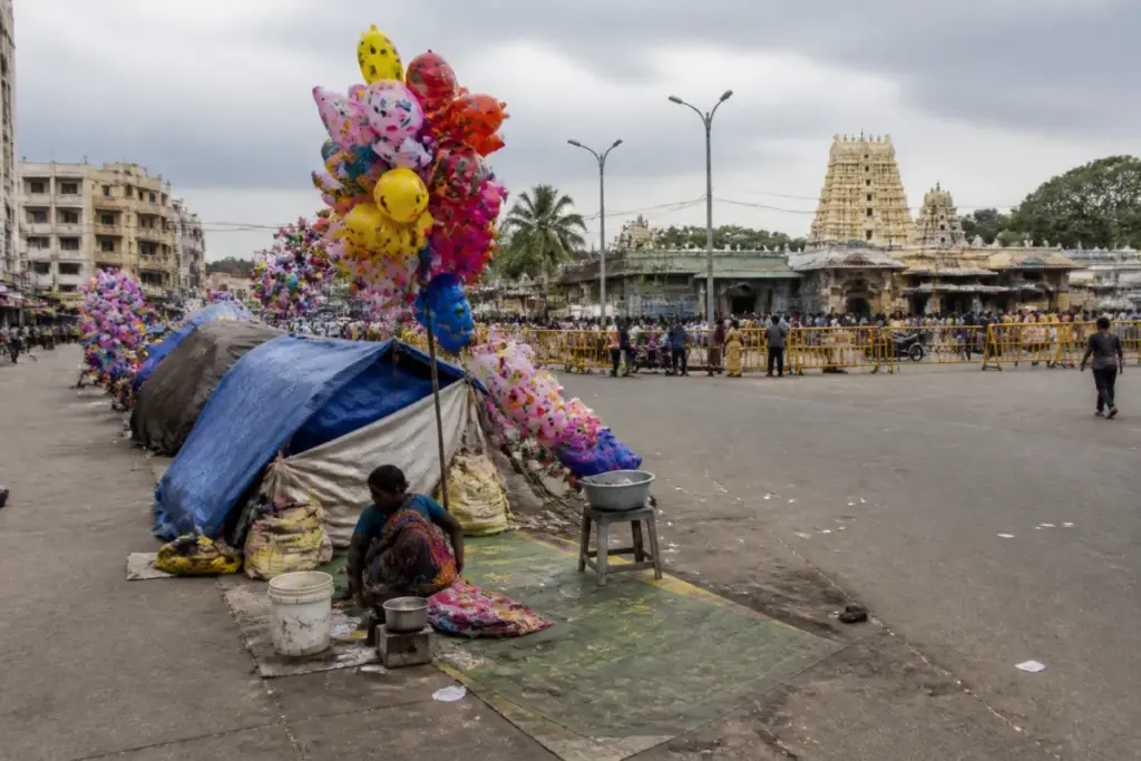 Mysuru Dasara crowd and temporary street-vending shelters near a city road