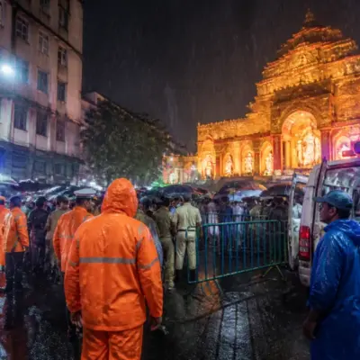 Crowd outside a Kolkata Durga Puja pandal during rain after a reported stampede