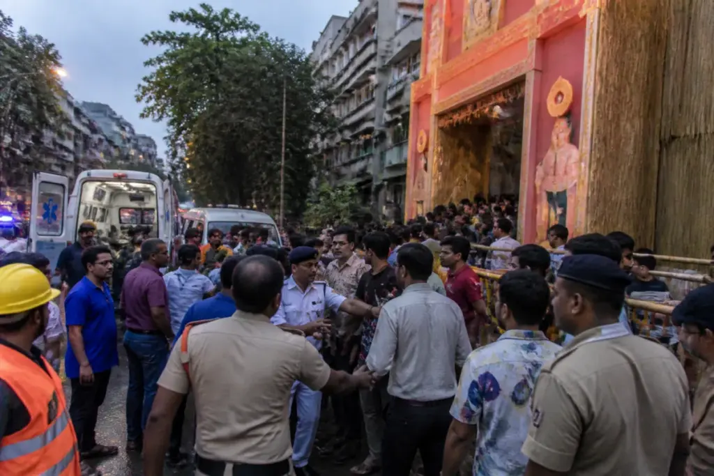 Crowd gathered outside a Kolkata Durga Puja pandal after a reported stampede