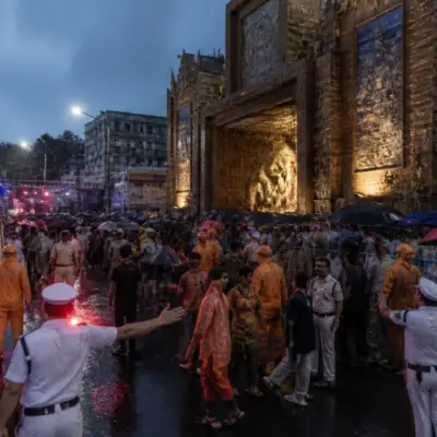 Kolkata pandal accident scene with crowds and emergency responders outside a Durga Puja venue