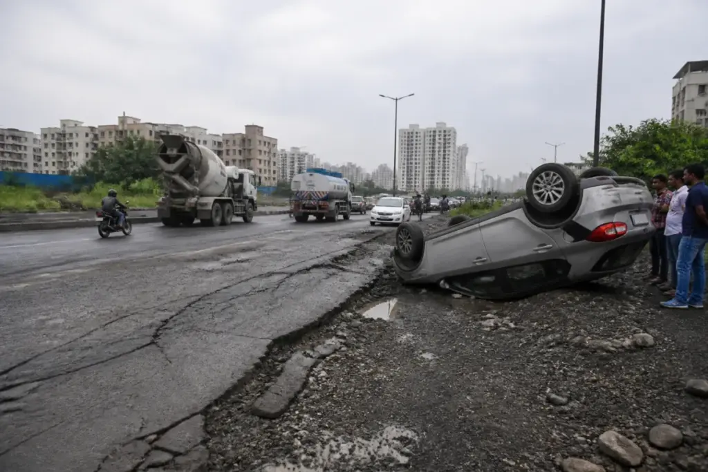 Damaged Undri Road in Pune after a car overturns near The Corinthians Club