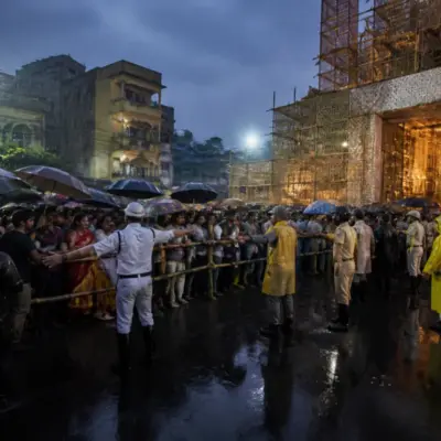 Crowd outside a Kolkata Durga Puja pandal during heavy rain