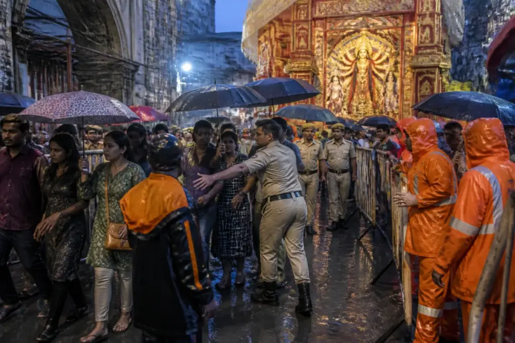 Crowd outside a Kolkata Durga Puja pandal after a reported stampede during rain
