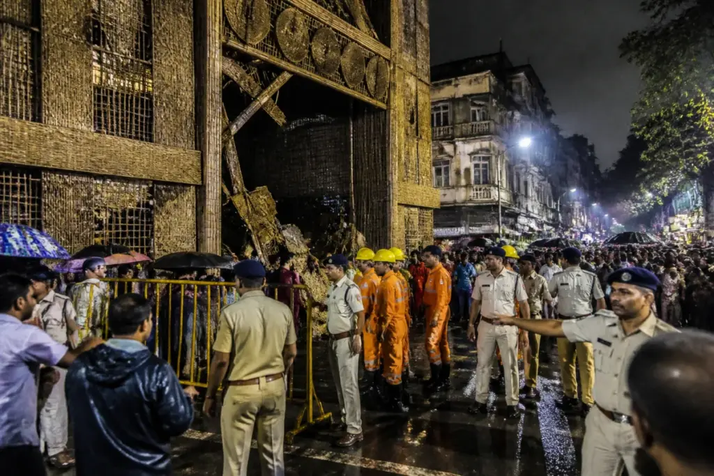Kolkata pandal accident site with a crowded Durga Puja entrance secured by police