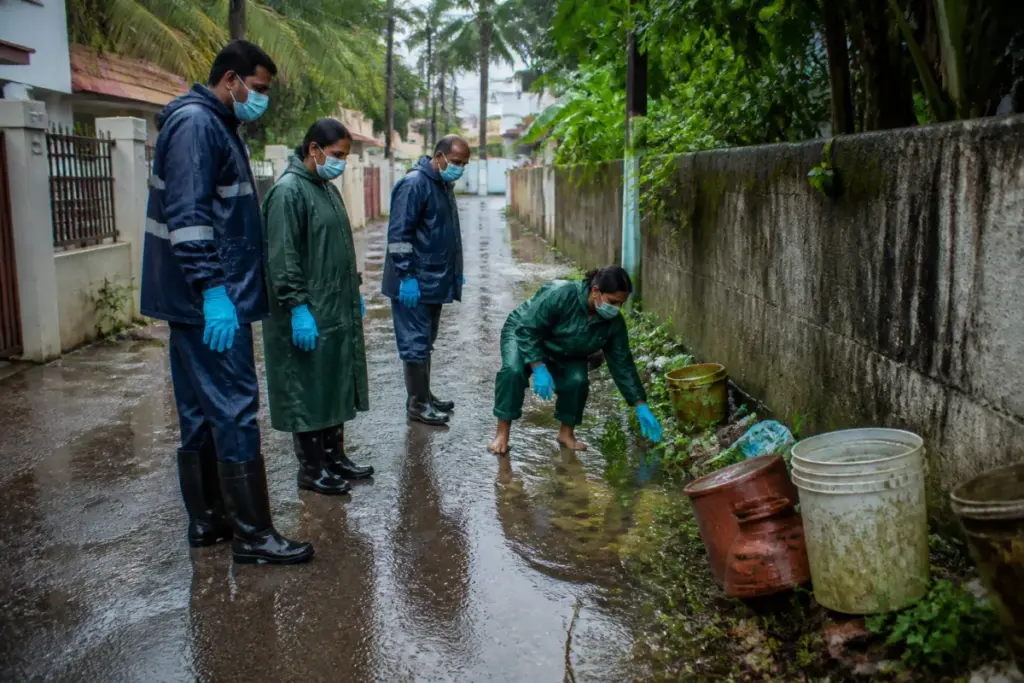 Leptospirosis prevention workers inspecting a waterlogged area in Thiruvananthapuram